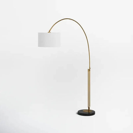 Curved brass Elegant Joan Arched Floor Lamp with white drum shade and black base