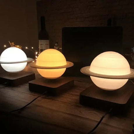 Illuminated planet-shaped night light lamps with rings on wooden bases for decor