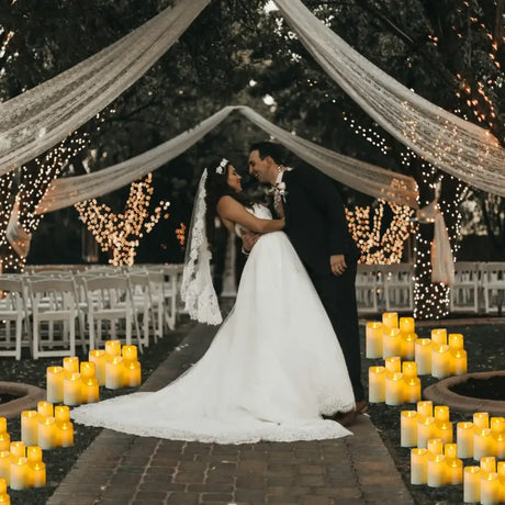 Romantic wedding couple under twinkling lights with LED flameless candles for decor
