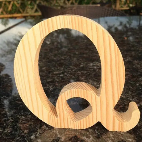 Wooden letter Q with cursive design ideal for photo frames or as a perfect gift